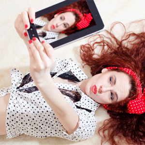 Woman taking selfie from Shutterstock