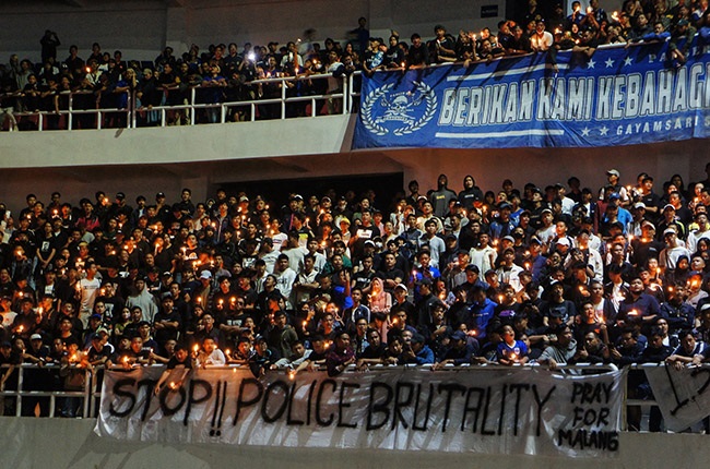 Football supporters attending a candlelight vigil 