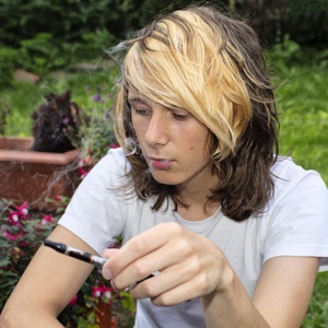Teenage boy smoking an electronic cigarette from Shutterstock