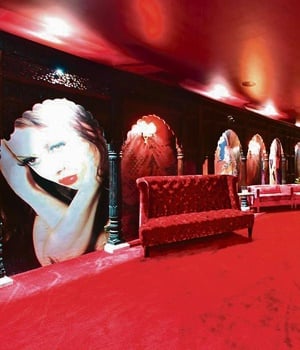 The cinema room is fitted with Moroccan arches and frescoes of women in various stages of undress. 