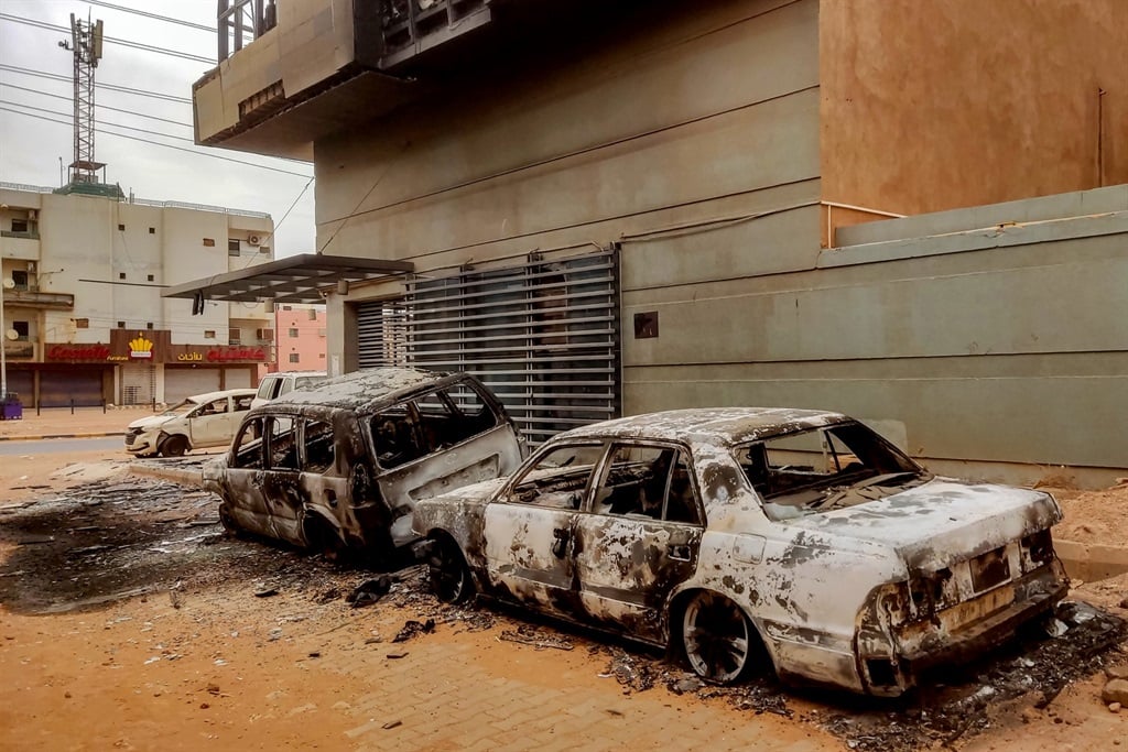 Destroyed vehicles are pictured outside the burnt-down headquarters of Sudan's Central Bureau of Statistics in the south of Khartoum, in May 2023. 