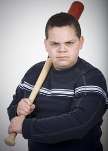 Boy threatening with a baseball bat from Shutterstock