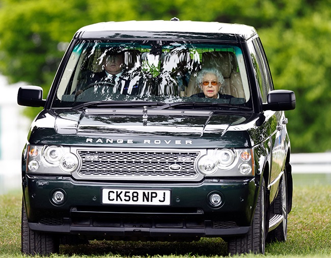 Queen Elizabeth watches, from inside her chauffeur