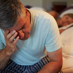 Man suffering with insomnia from Shutterstock