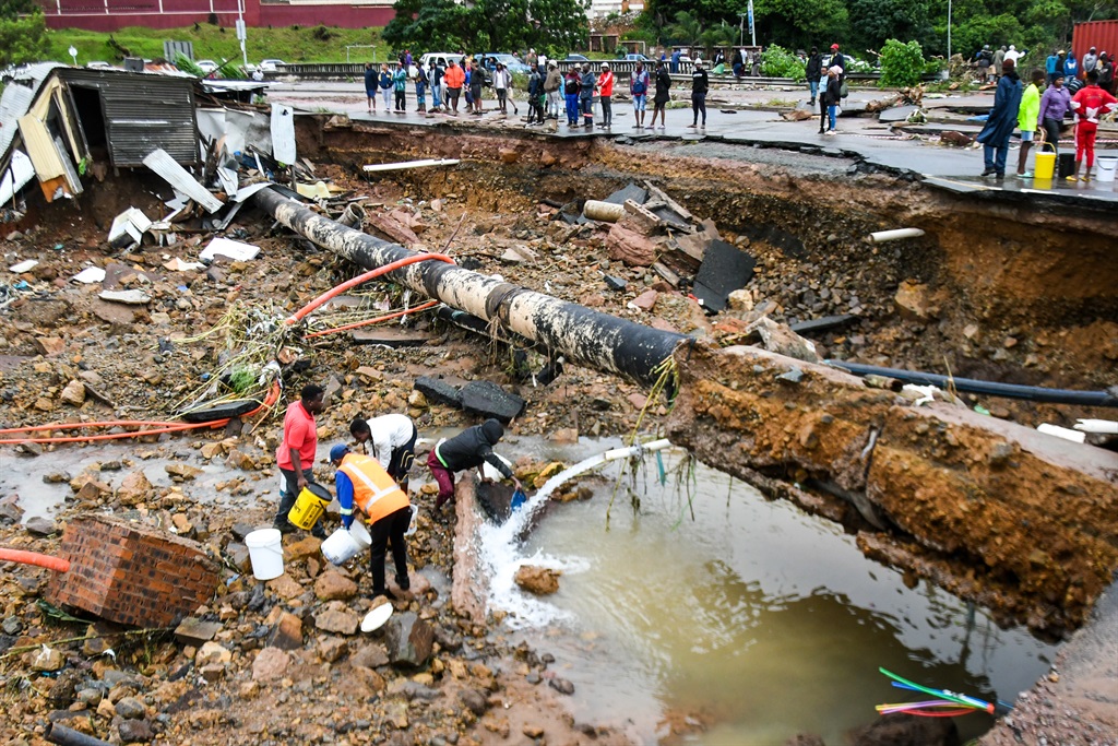 Residents collect fresh water at an informal settlement between the M19 and Quarry Road in Durban on 12 April 2022.