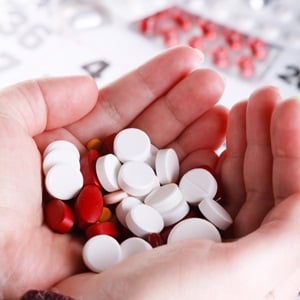 Pills on the hand from Shutterstock