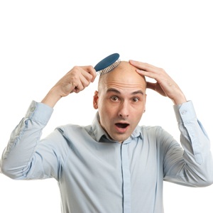 Shocked bald man holding comb from Shutterstock