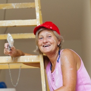 Older woman on ladder from Shutterstock