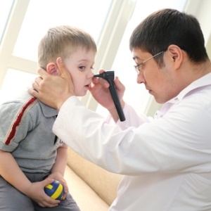 Doctor examining child's ear from Shutterstock