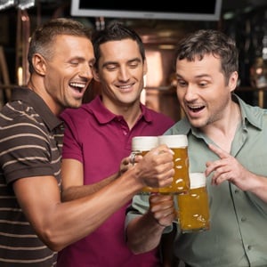 Happy friends drinking beer from Shutterstock