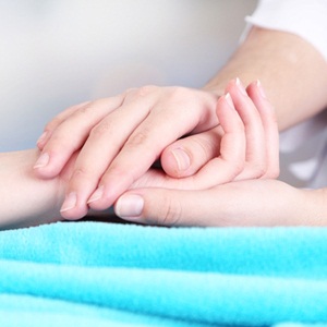 Holding hand of patient from Shutterstock