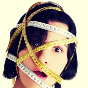 Woman with measuring tape around her head from Shutterstock