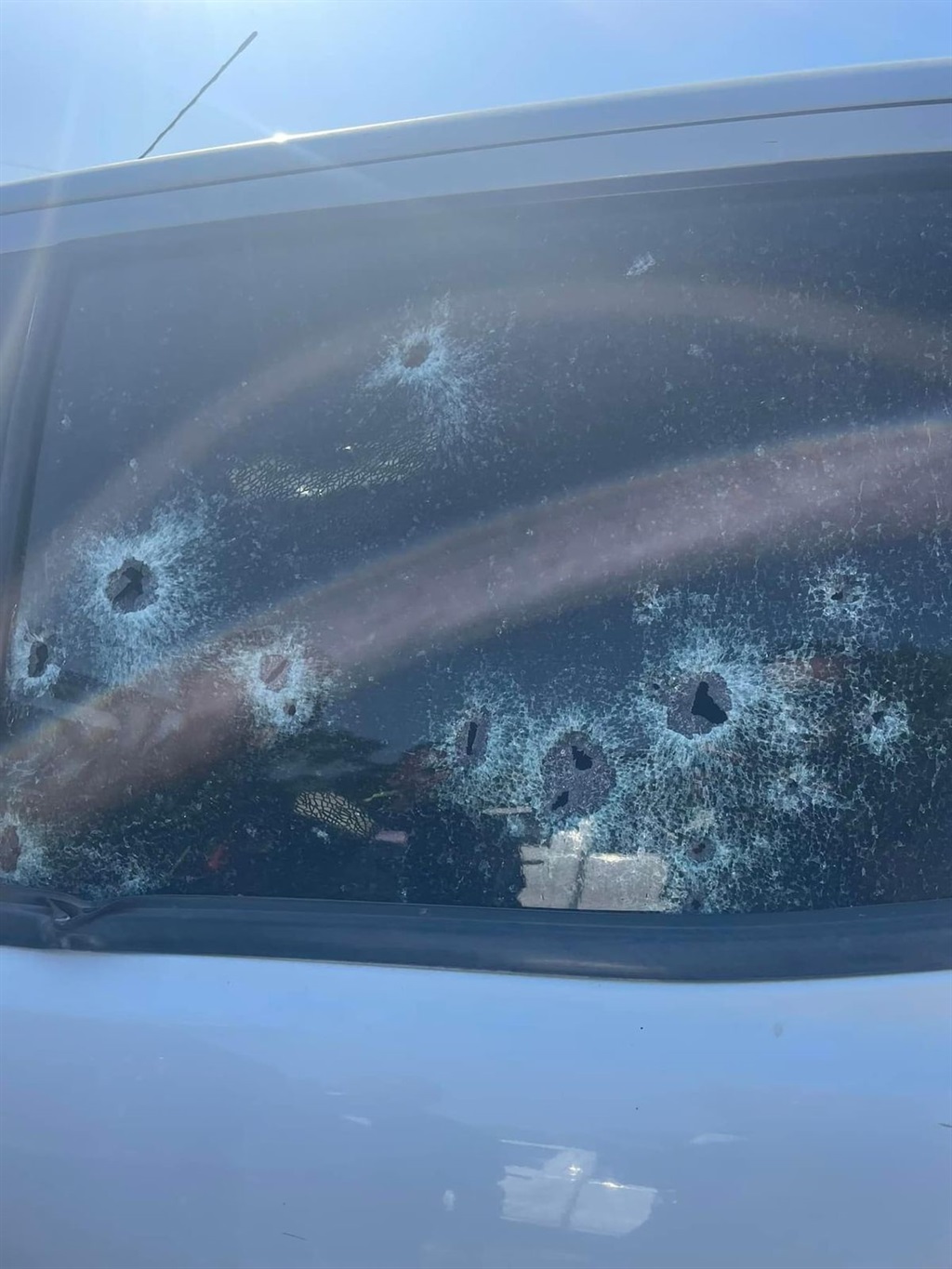 Bullet holes in the windscreen of the vehicle. Bullet holes in the windscreen of the vehicle.