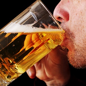 Man drinking a glass of beer from Shutterstock
