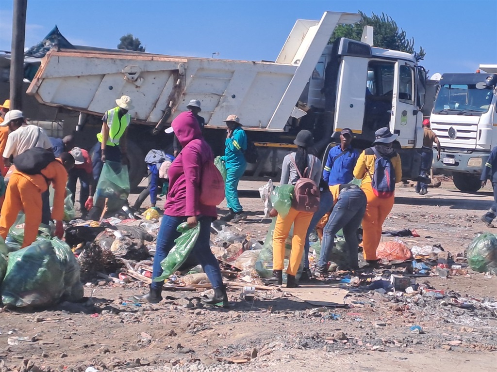 Residents and Ekurhuleni city officials clean Tembisa after waste contractors refused to collect due to non-payment.