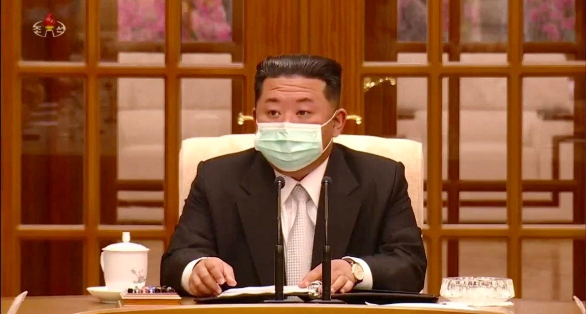 North Korean leader Kim Jong Un seen wearing a mask in images broadcast by state-run media on May 12, 2022.