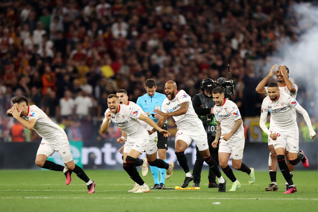 BUDAPEST, HUNGARY - MAY 31: Players of Sevilla FC celebrate after Gonzalo Montiel of Sevilla FC (not pictured) scores the teams fourth penalty in the penalty shoot out during the UEFA Europa League 2022/23 final match between Sevilla FC and AS Roma at Puskas Arena on May 31, 2023 in Budapest, Hungary. (Photo by Maja Hitij/Getty Images)