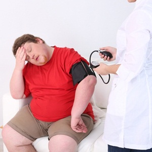 Doctor examining patient obesity from Shutterstock