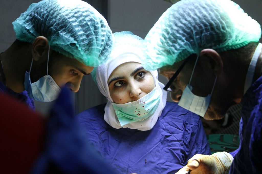 Al Ghouta, Syria - Nurse Samaher (center) in the o