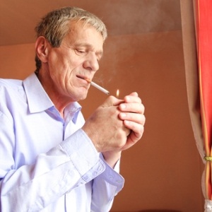 Older man smoking from Shutterstock