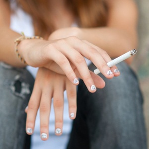 Teenage hands holding cigarette from Shutterstock