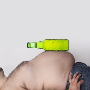 Fat stomach with beer bottle from Shutterstock
