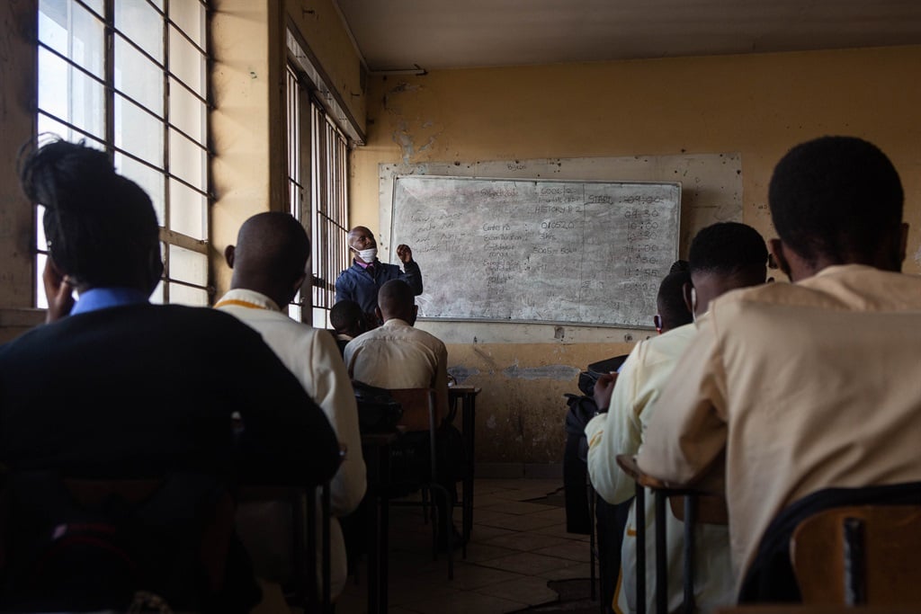 A teacher conducts a lesson to students in Harare, Zimbabwe. 