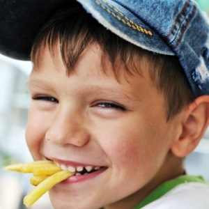 Kid eating junk food from Shutterstock