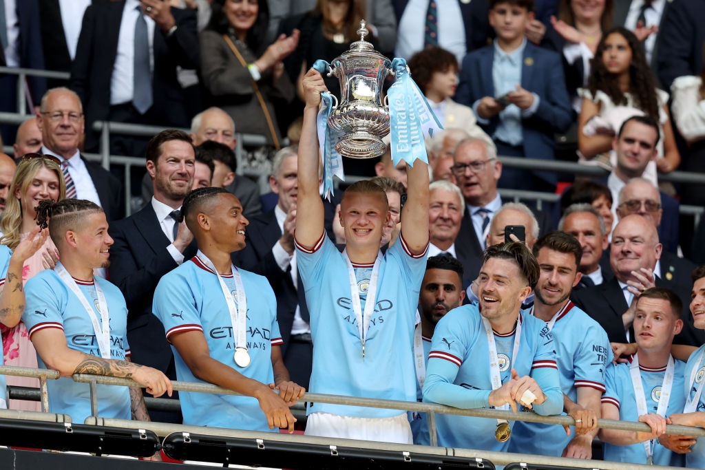 LONDON, ENGLAND - JUNE 3: Erling Haaland of Manchester City llifts the FA Cup Trophy after the 2-1 victory during the  Emirates FA Cup Final match between Manchester City and Manchester United at Wembley Stadium on June 03, 2023 in London, England. (Photo by James Williamson - AMA/Getty Images)