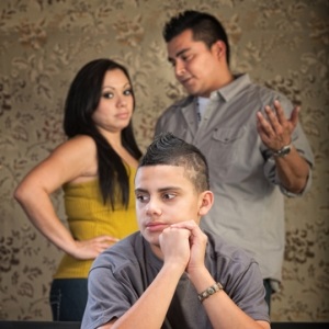 Boy with concerned parents from Shutterstock