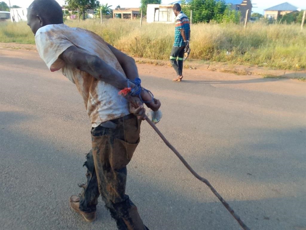 The alleged tsotsis were tied with ropes by angry 