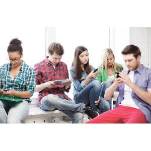 Students looking at their phones and tablet pc from Shutterstock