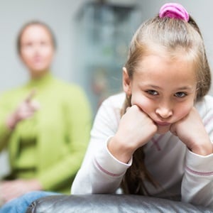 A woman scolding a sad little daughter. (Shutterstock)