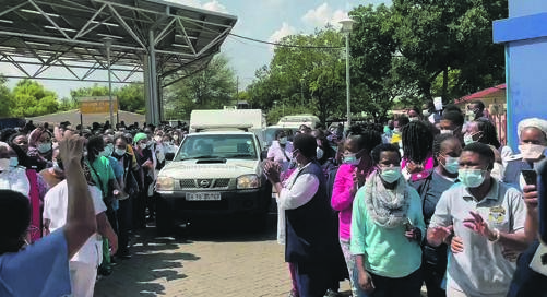 HOSPITAL’S PAIN: The body of Lebo Monene, who died yesterday at Tembisa Hospital, being taken by the forensic van while staff form a guard of honour for their dead colleague.                 Screengrab from             Twitter