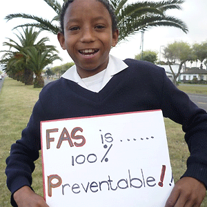 A child holds a poster showing that FAS is 100% preventable. From http://www.takeawaytheatre.com