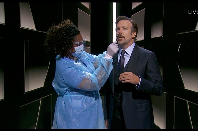 Nicole Butler taking a nasal swab from actor Jason