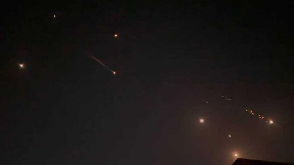 This video screengrab from AFPTV shows explosions lighting up the sky in Hebron, Palestinian Territories, during an Iranian attack on Israel. Iran's Revolutionary Guards confirmed early on 14 April 2024 that a drone and missile attack was under way against Israel in retaliation for a deadly drone strike on its Damascus consulate. (AFPTV/AFP)