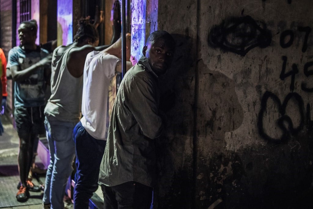 Suspects are lined up against a wall as members of the South African Police Service arrest them because they defied the lockdown order during an operation in the Johannesburg CBD. 