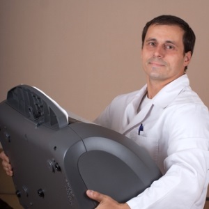 Doctor with portable X-ray equipment from Shutterstock