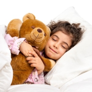 Girl sleeping with teddy from Shutterstock