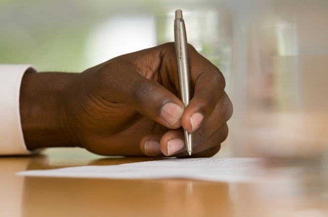 A man signing a legal document.