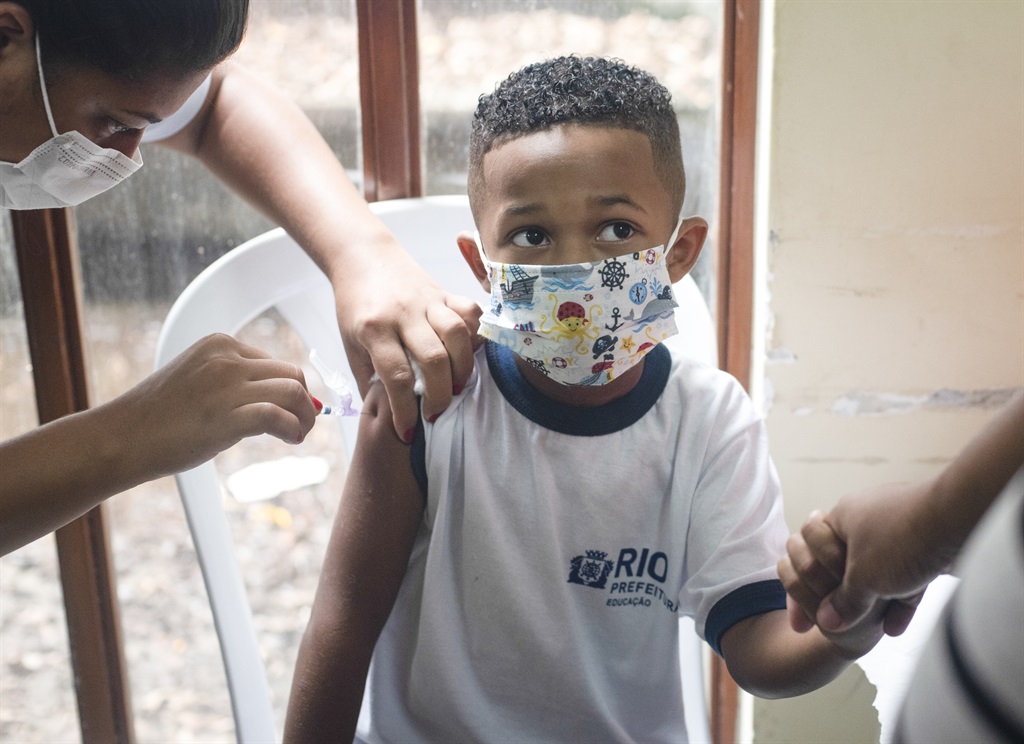 A child receives a Covid-19 vaccine. (Photo by Fabio Teixeira/Anadolu Agency via Getty Images)