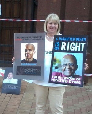 Dignity SA member Patsy Schonegevel stands outside the North Gauteng High Court holding a picture of her son Craig. (Thomas Hartleb, News24)