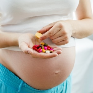 Pregnant mom with supplements from Shutterstock