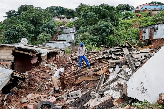 Residents salvage the remains of destroyed buildings in Clermont, near Durban.