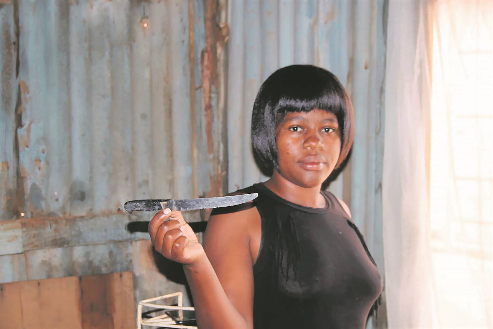 Smangele Dladla holds a knife believed to have been used in the murder of her uncle.     Photo by      Phineas Khoza