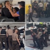 WATCH | Woman tries to bite police officers after causing a disturbance on a plane