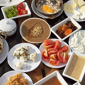 A traditional Turkish breakfast of full-fat  soft cheese, beans, eggs, hummus and vegetables.
