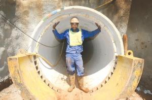 A worker demonstrates the size of the award-winning concrete sleeve constructed on Town Hill to house a new water pipeline for Umgeni Water.