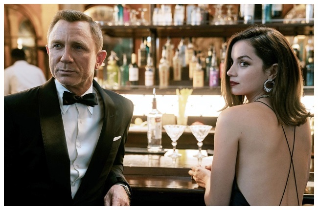 Spies James Bond (Daniel Craig) and Paloma (Ana de Armas) are ready for action in No Time To Die. (PHOTO: Universal Pictures)